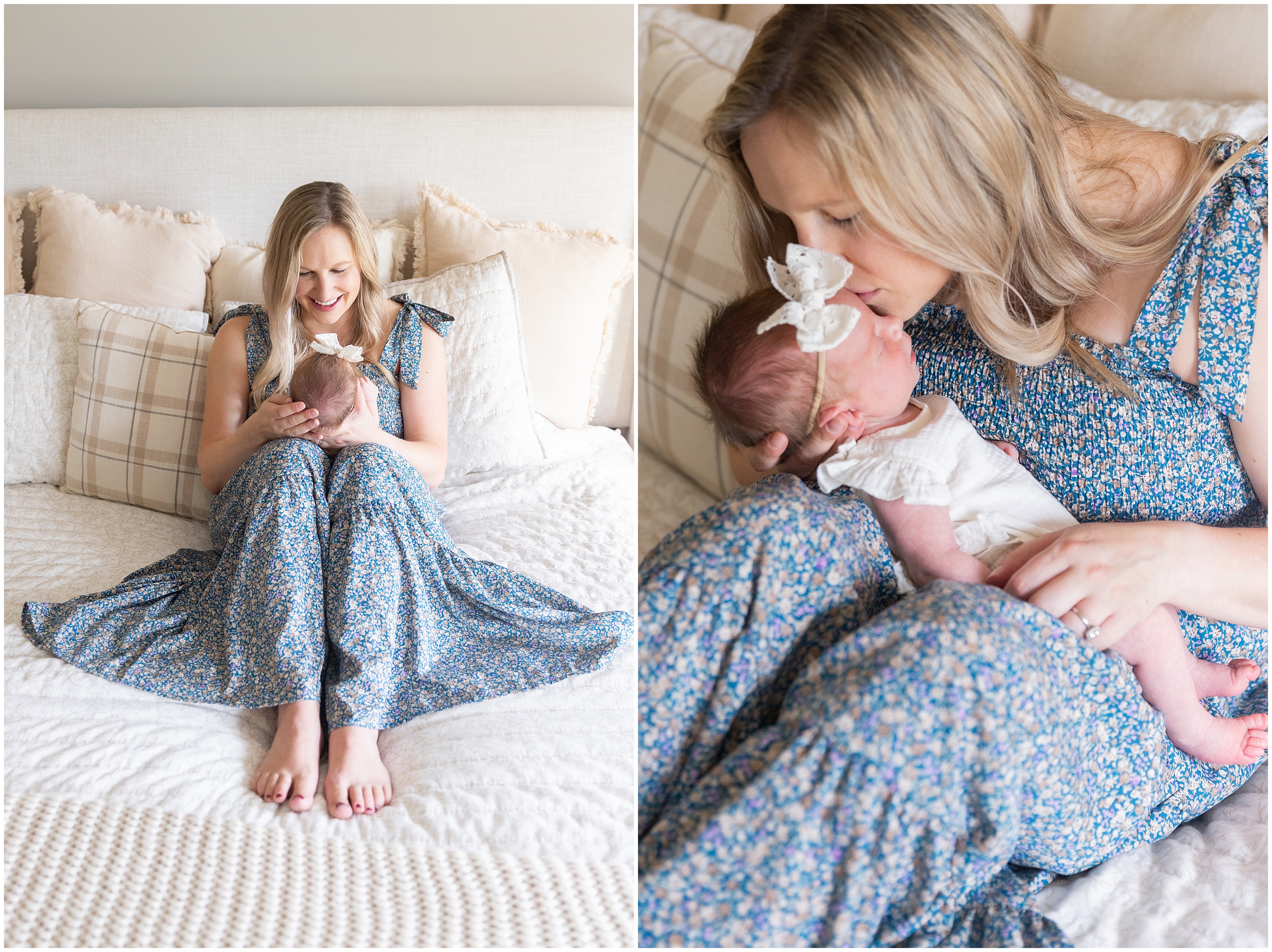 Smiling blonde mother in blue floral dress kisses her newborn on a white bed with cream pillows in a soft, cozy bedroom. Columbus Ohio newborn photography